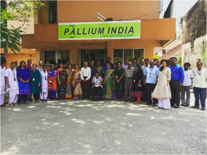 Pallium India team in front of Arumana Hospital building